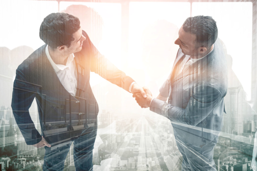 two businessmen shaking hands on becoming strategic partners