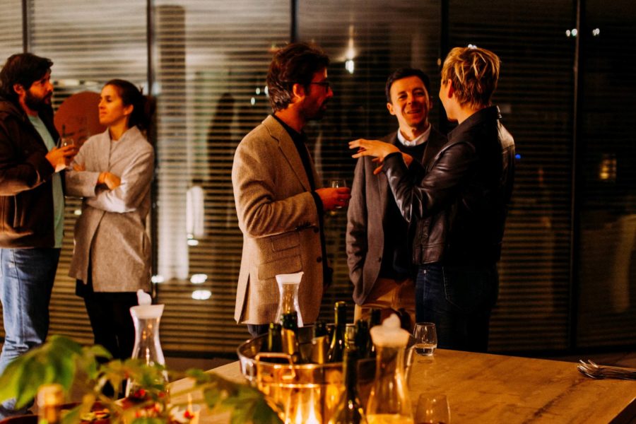 Group of young professionals engaged in business networking in days before social distancing