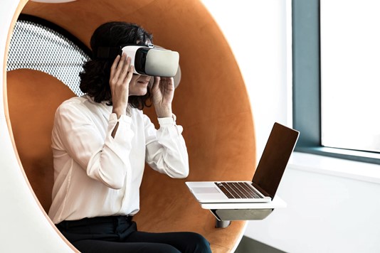 Woman uses VR headset in office