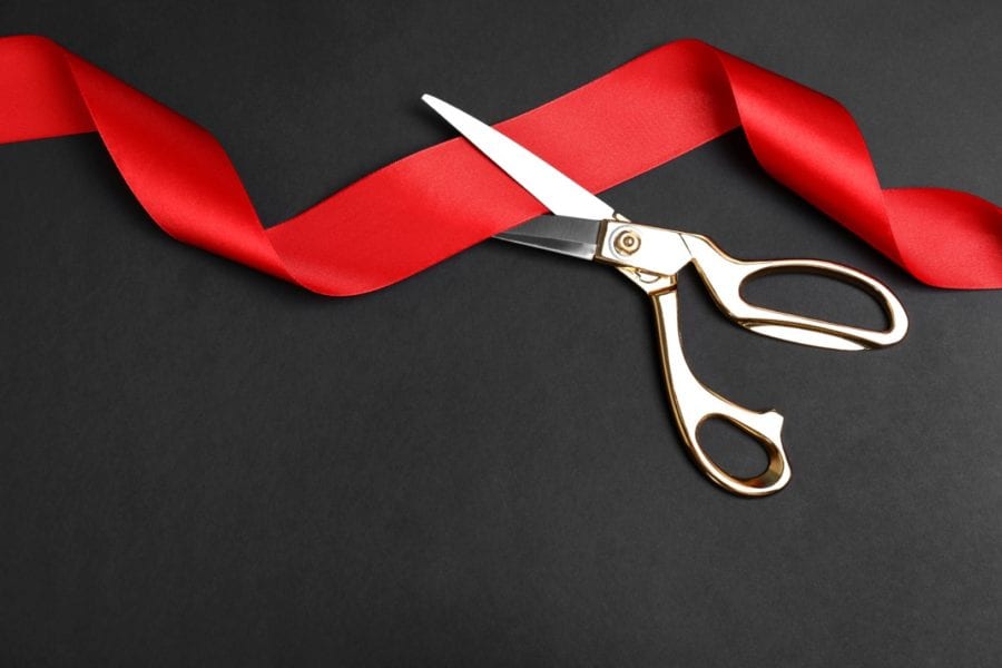 Red tape draped between scissor blades